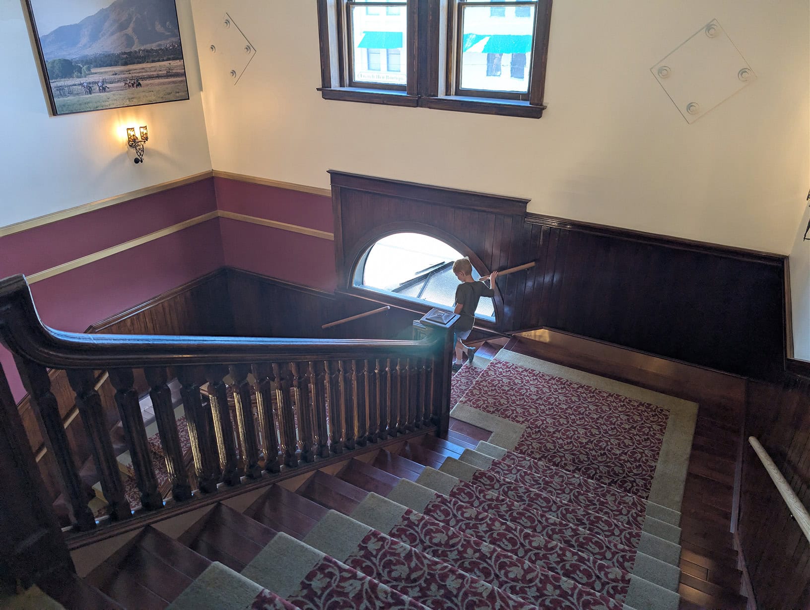 Reid walking down the grand staircase at the Hotel St. Michael